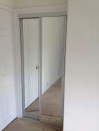 Mirror sliding wardrobe doors with matt silver frames