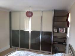 Starlight black and pearl white glass doors with a polished silver frame
