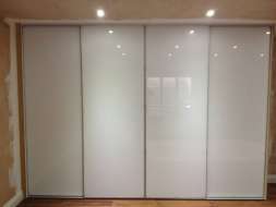 Plain white glass wardrobes doors with a minimal frame (straight on view)