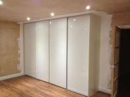 Plain white glass wardrobes doors with a minimal frame (from the right view)
