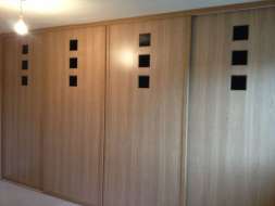 Small black glass squares in an oak effect panel