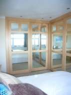 White beech and mirror doors with our seaton design, in an L shape wardrobe