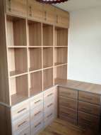 L shape unit of drawers with an open bookcase above