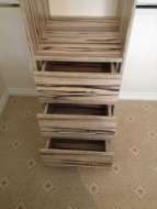 Chest of drawers built-into a column of shelves (drawers stepped open)