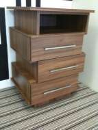 A funky offset bedside drawer chest with one open shelf (angled view)