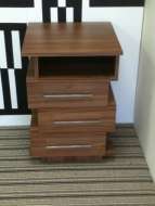A funky offset bedside drawer chest with one open shelf (from the front)