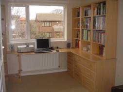 A full view of the corner desk and bookcase