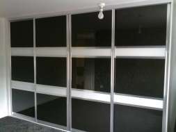Black glass doors with 2 white bands dividing the black into 3 sections