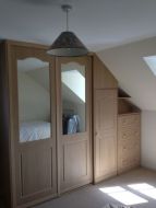 Sliding wardrobe with hinged doors going into the eaves