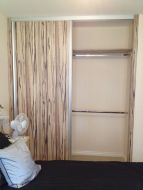 Artwood panel doors with matt silver frames, making a bold impression in the room (right door open)